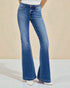 Blue flared jeans worn by a person on a beige background