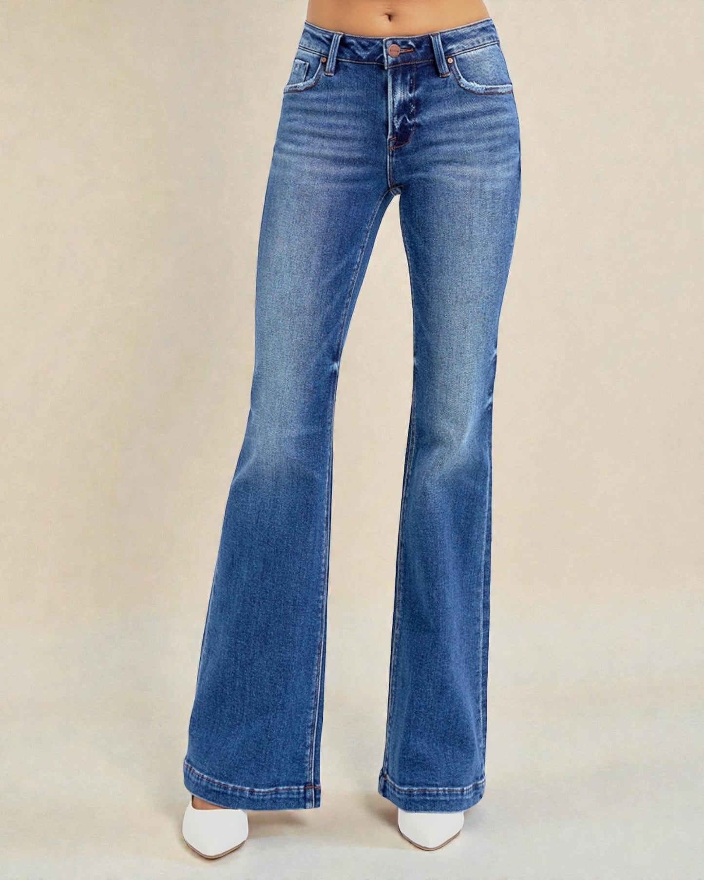 Blue flared jeans on a beige background