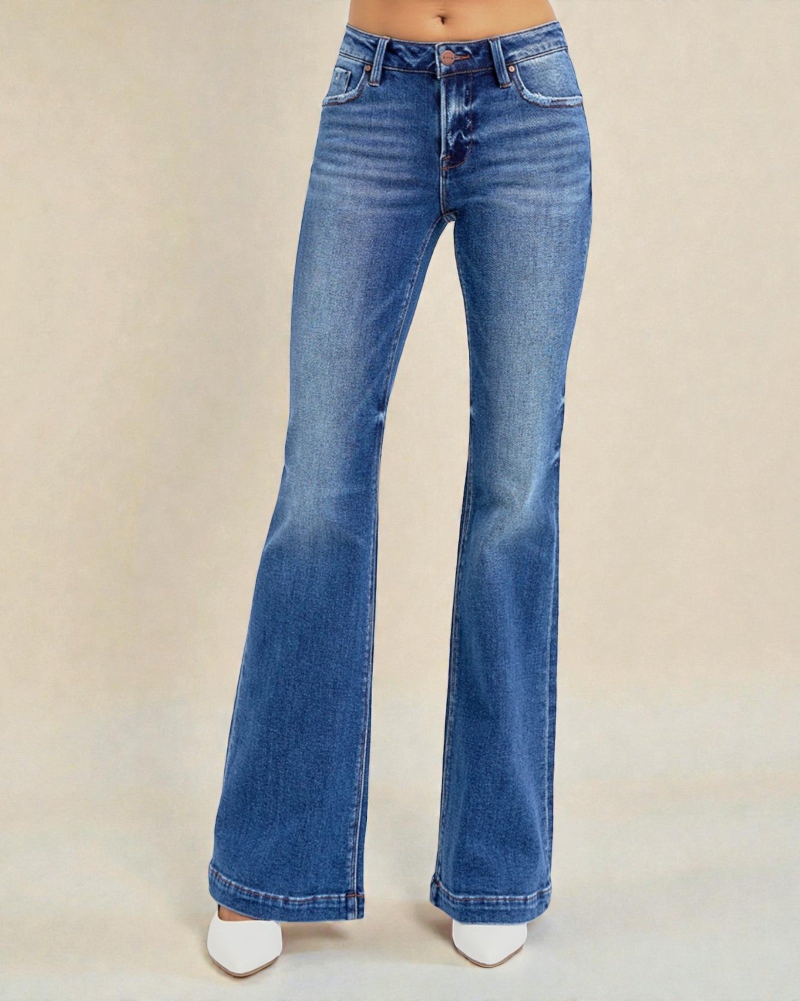 Blue flared jeans on a beige background