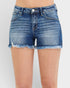 Blue denim shorts on a plain background