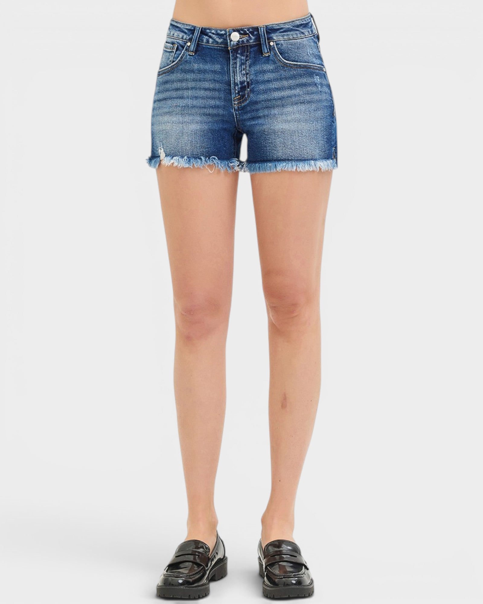 Denim shorts worn by a person on a white background