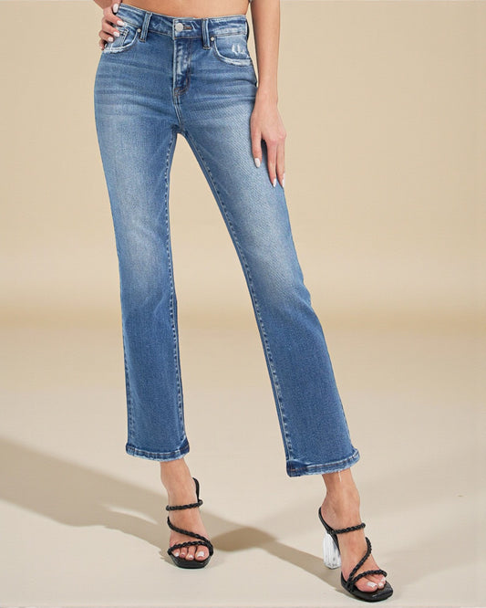 Person wearing blue jeans on a beige background