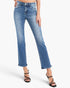 A model wearing a pair of medium-wash blue denim jeans with a straight-to-ripped leg and rolled hems, paired with black strappy high-heeled sandals against a plain white studio background.