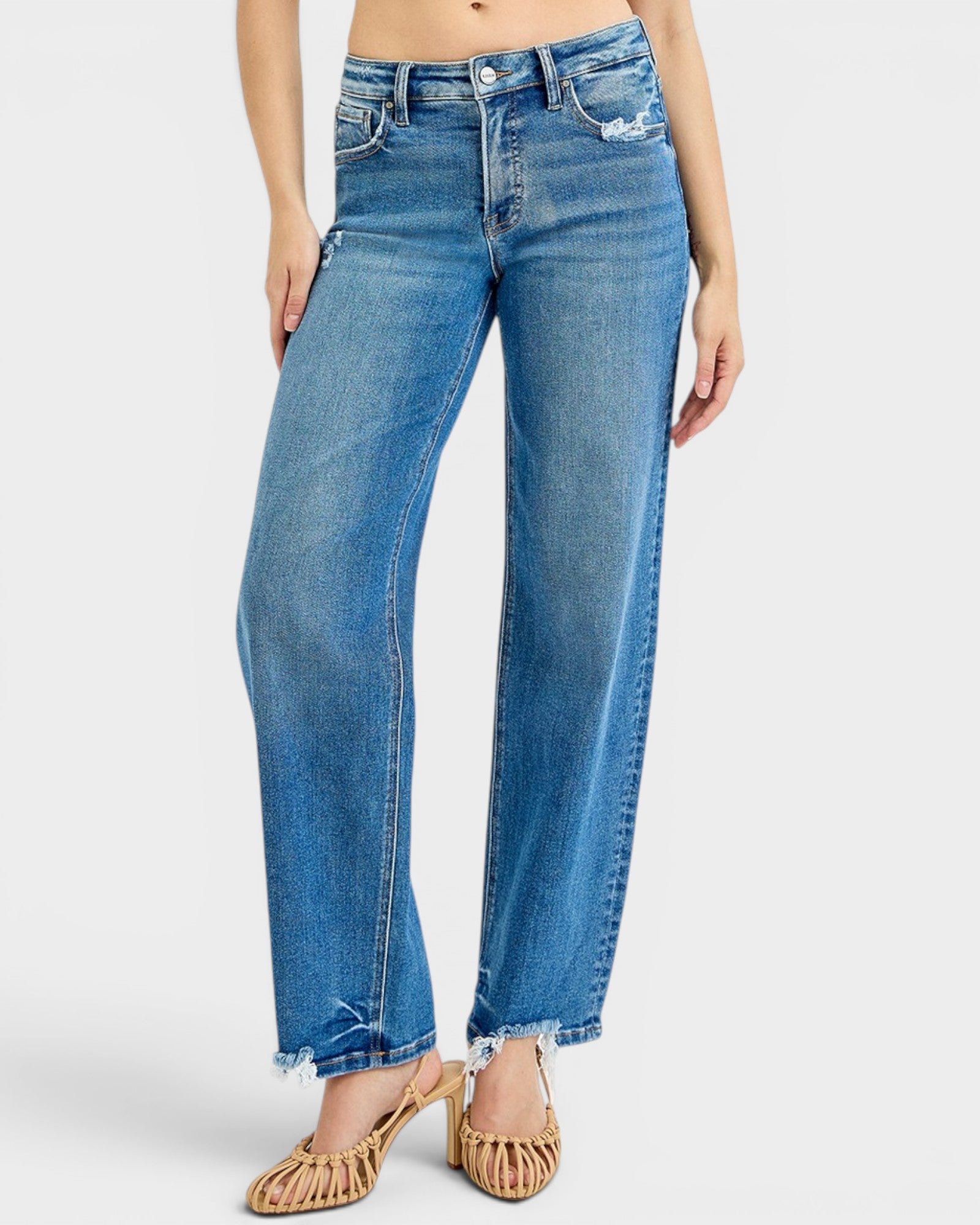 Blue jeans worn by a person on a white background