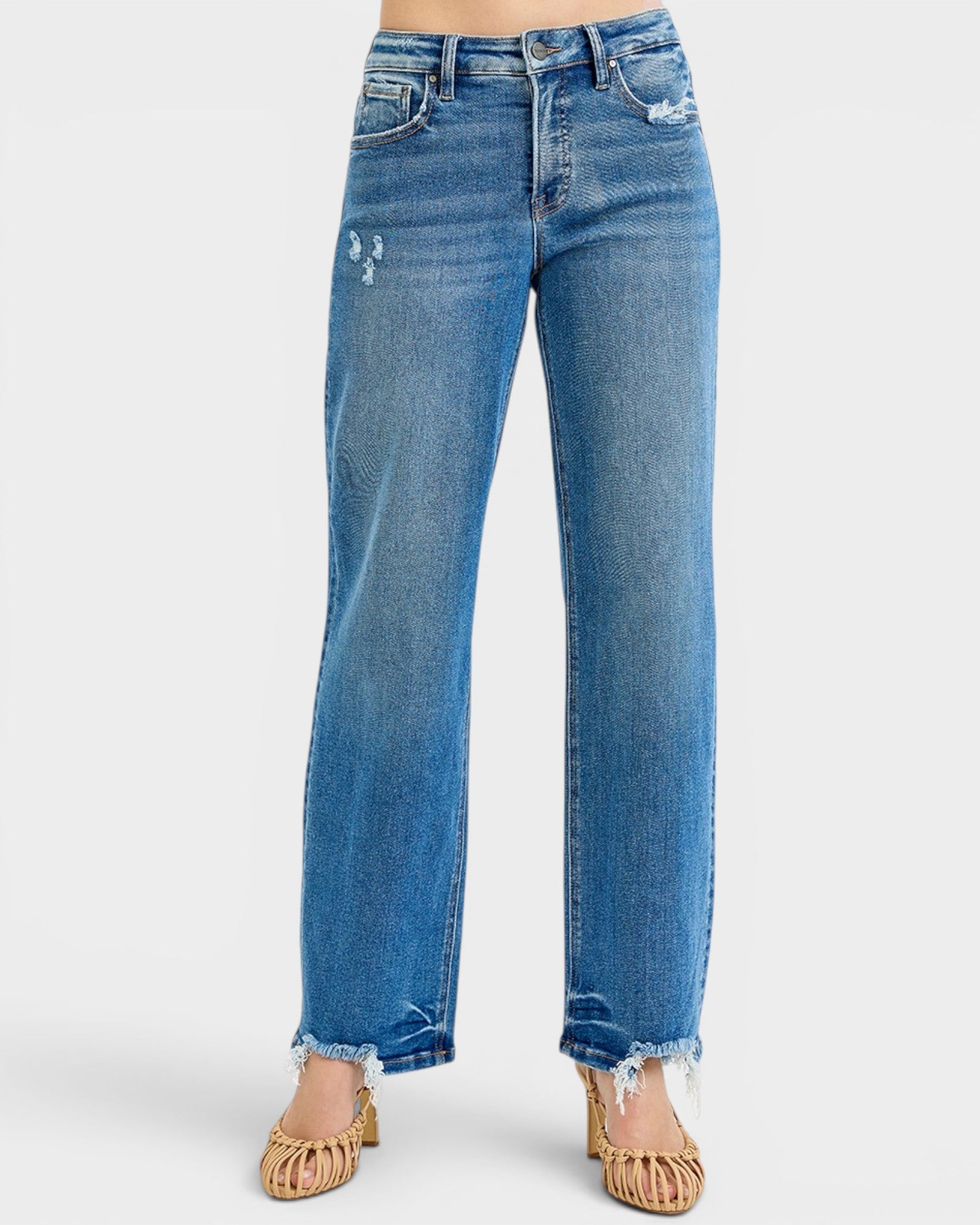 Blue jeans with frayed hems on a white background