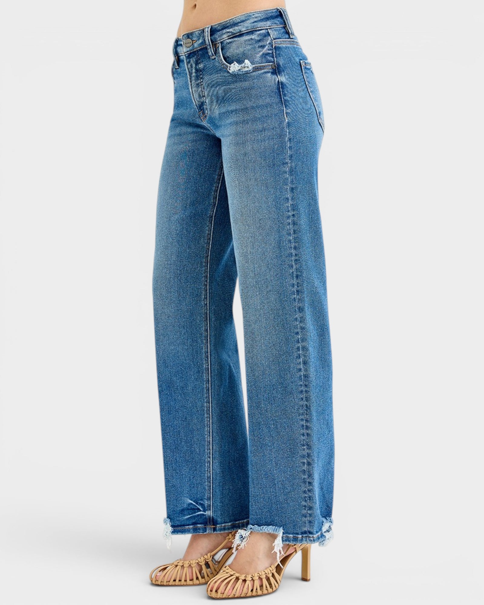 Blue jeans worn by a person on a white background