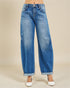 Blue jeans worn by a person on a beige background