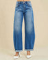 Blue jeans worn by a person on a beige background