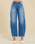 Blue jeans worn by a person on a beige background