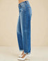 Blue jeans worn by a person on a beige background