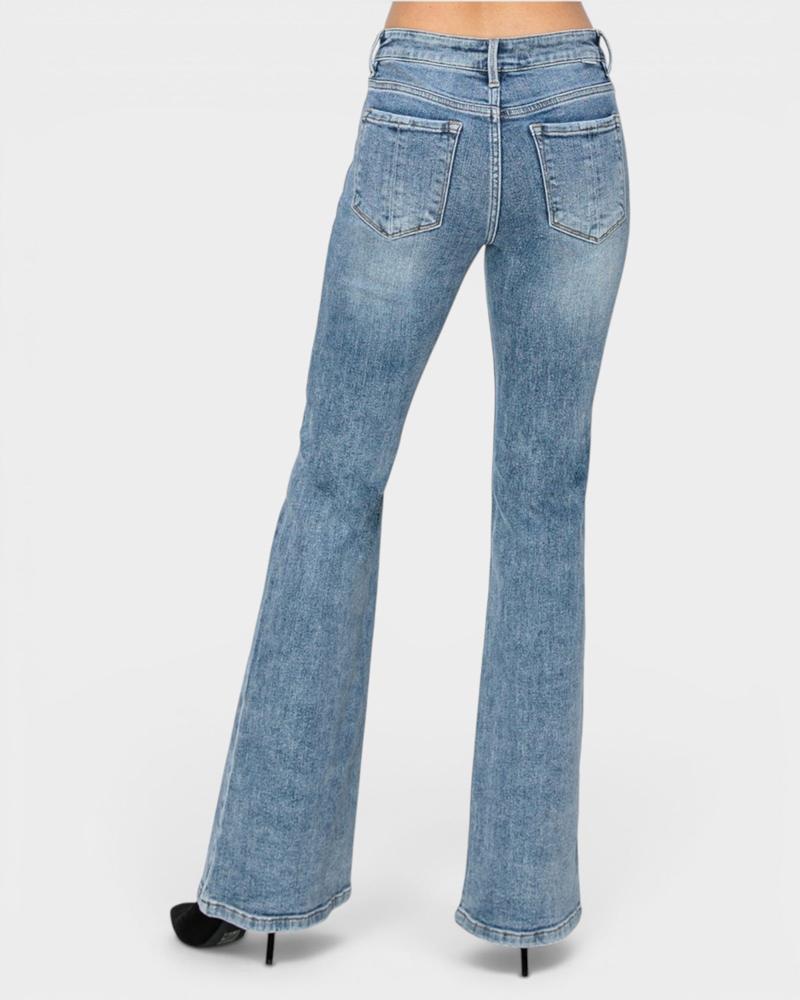 Light blue flared jeans on a white background