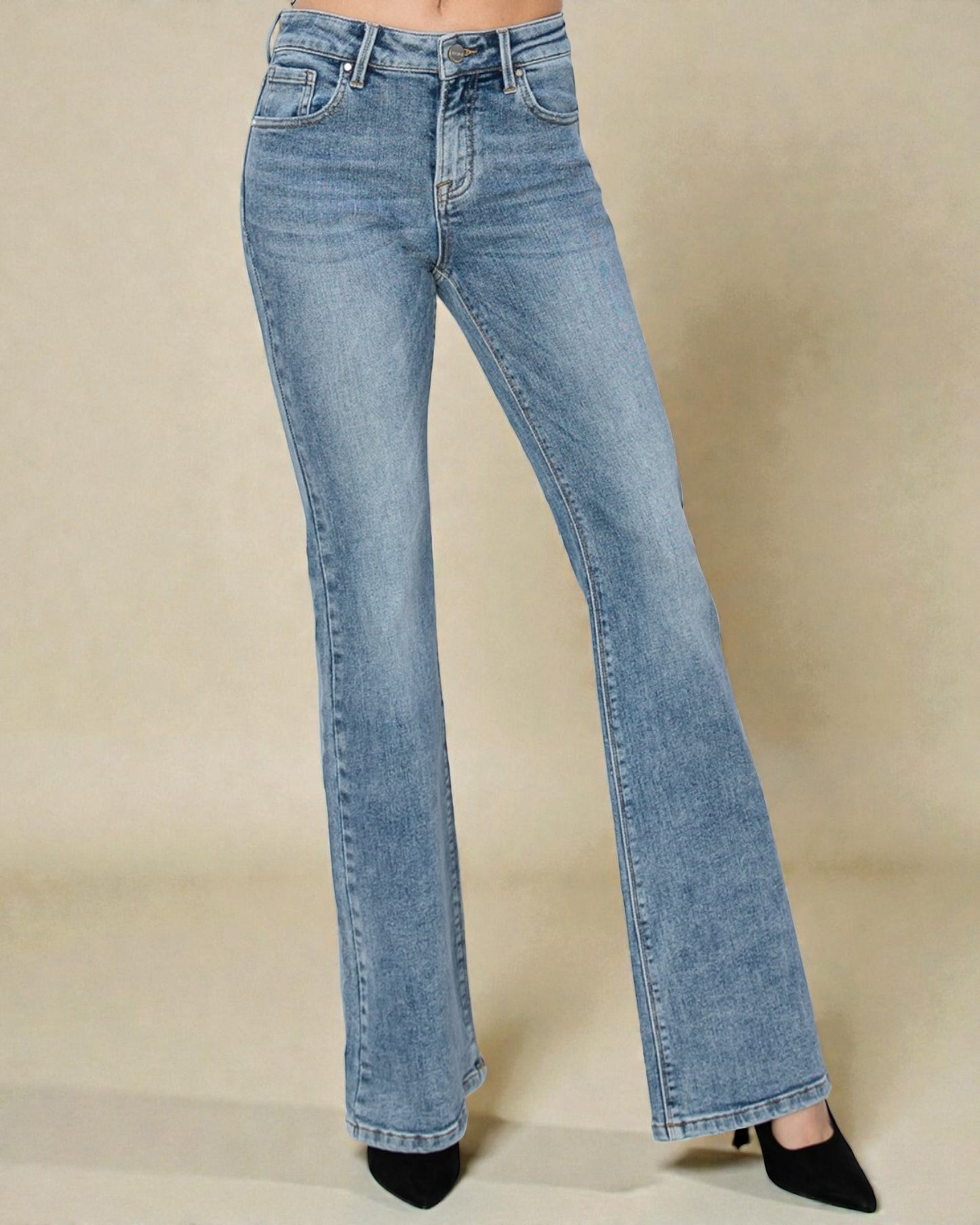 Light blue flared jeans on a beige background