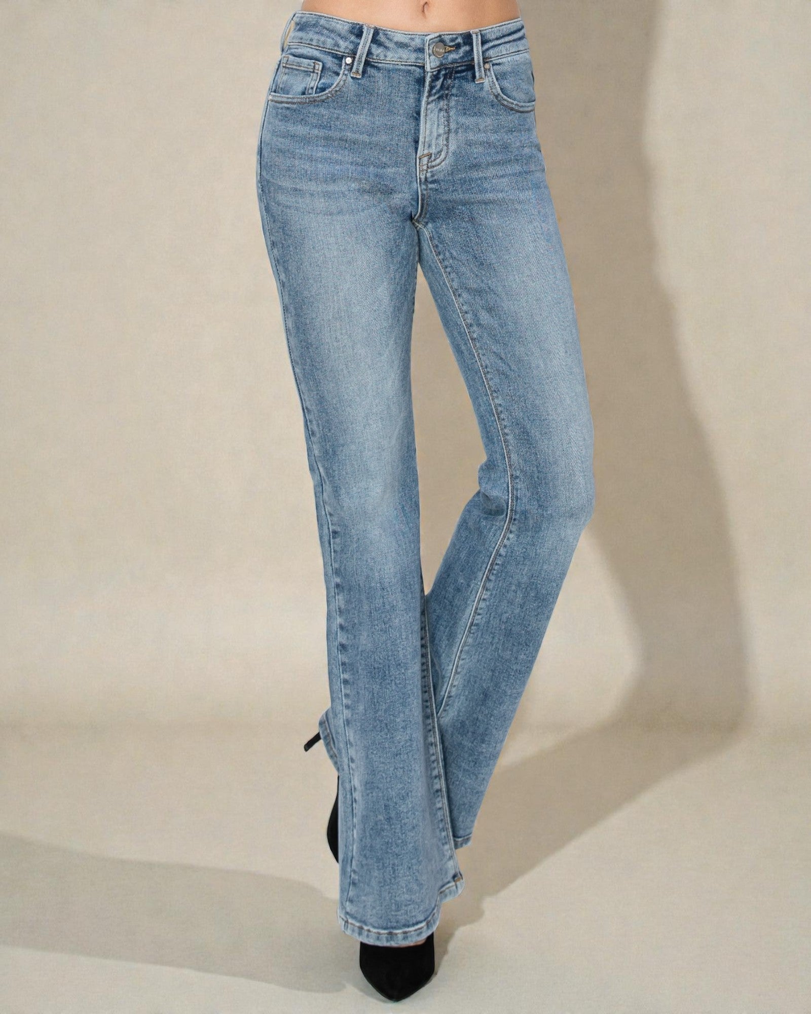 Light blue jeans on a beige background