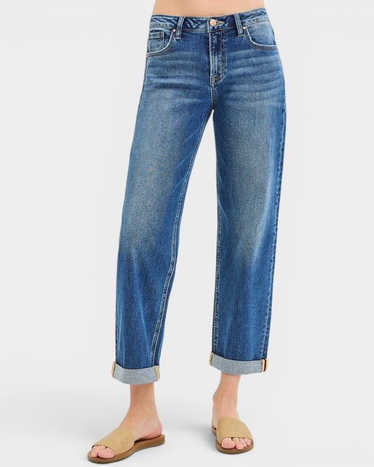 Blue jeans worn by a person on a white background