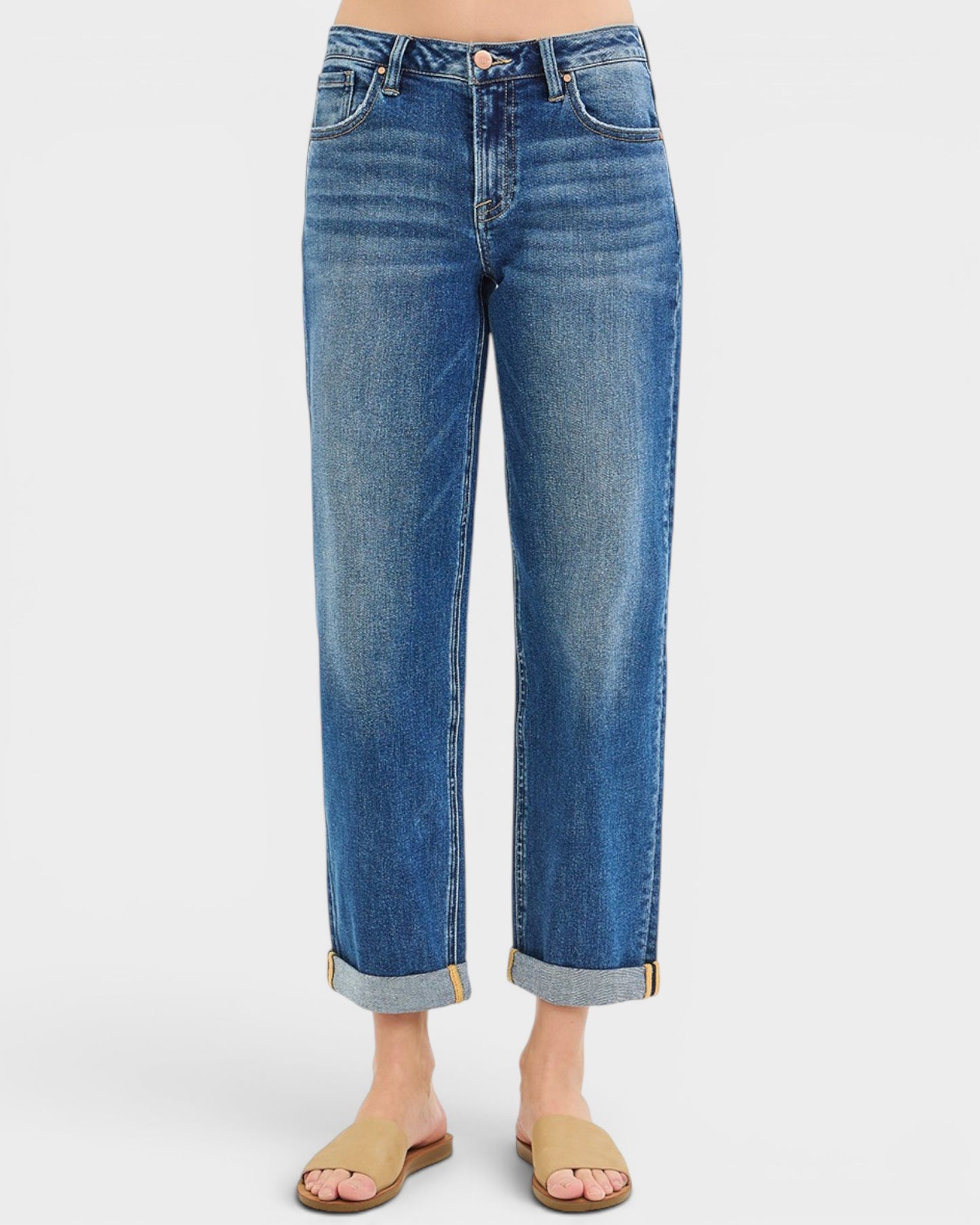 Blue jeans worn by a person on a white background