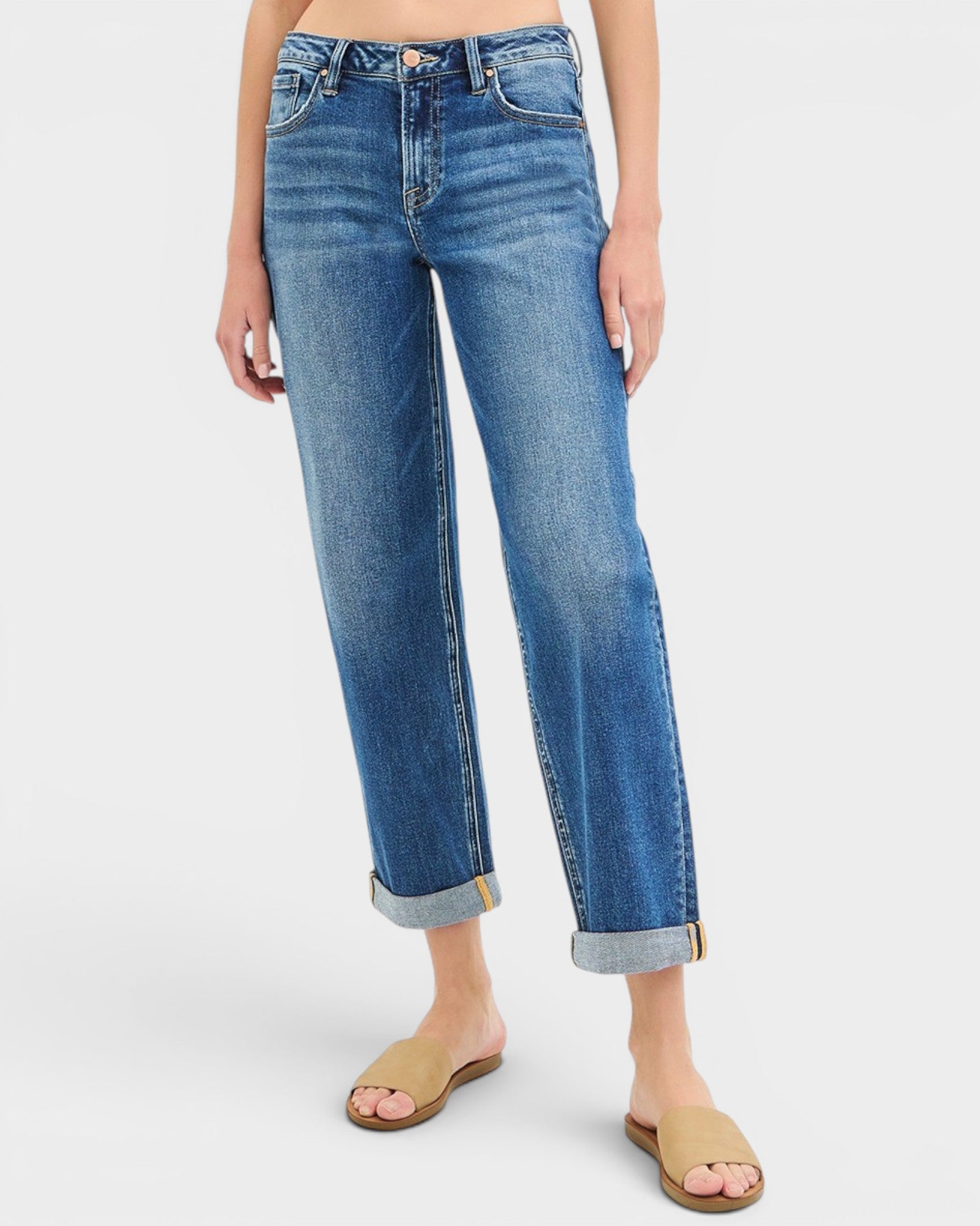Person wearing blue jeans on a white background
