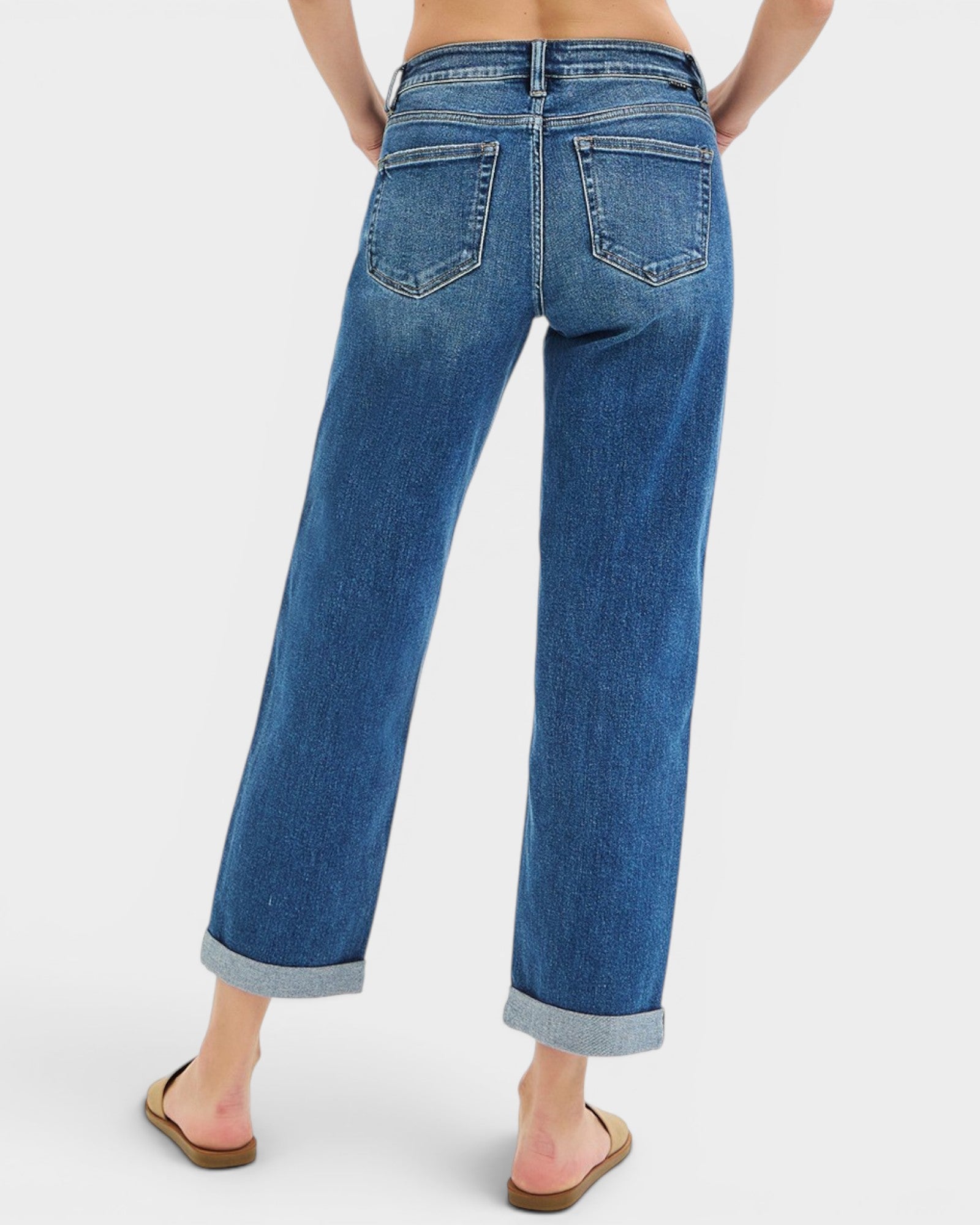 Blue jeans worn by a person on a white background