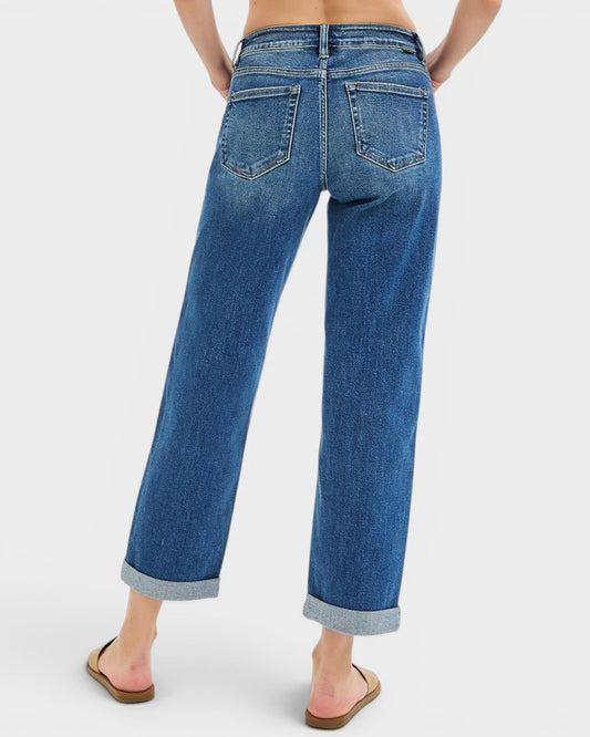 Blue jeans worn by a person on a white background
