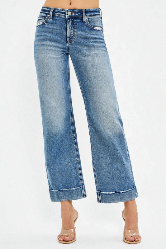 Blue jeans worn by a person on a white background