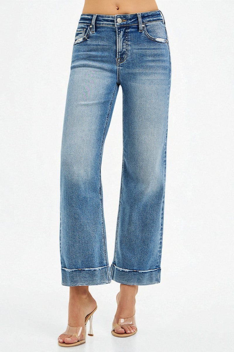 Blue jeans worn by a person on a white background