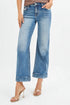 Light blue jeans worn by a person on a white background