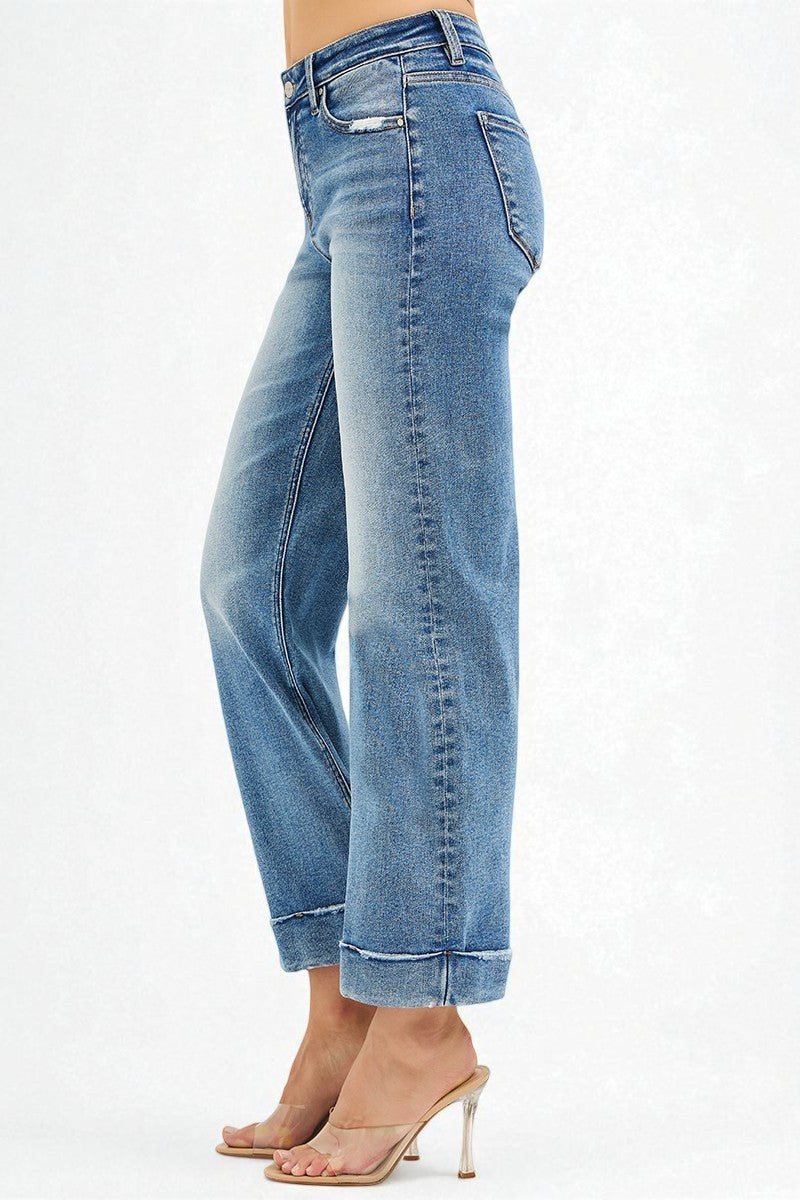 Blue jeans worn by a person on a white background