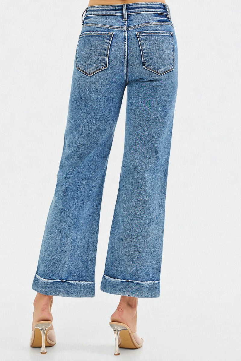 Blue jeans worn by a person on a white background