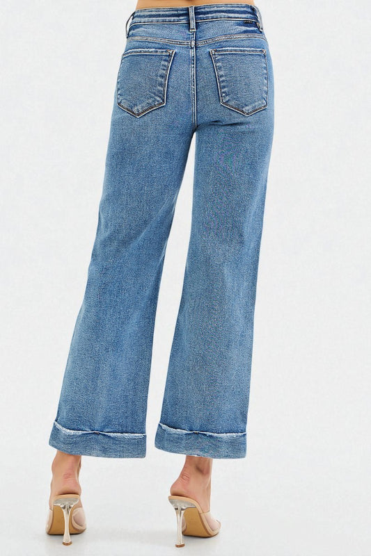 Blue jeans worn by a person on a white background
