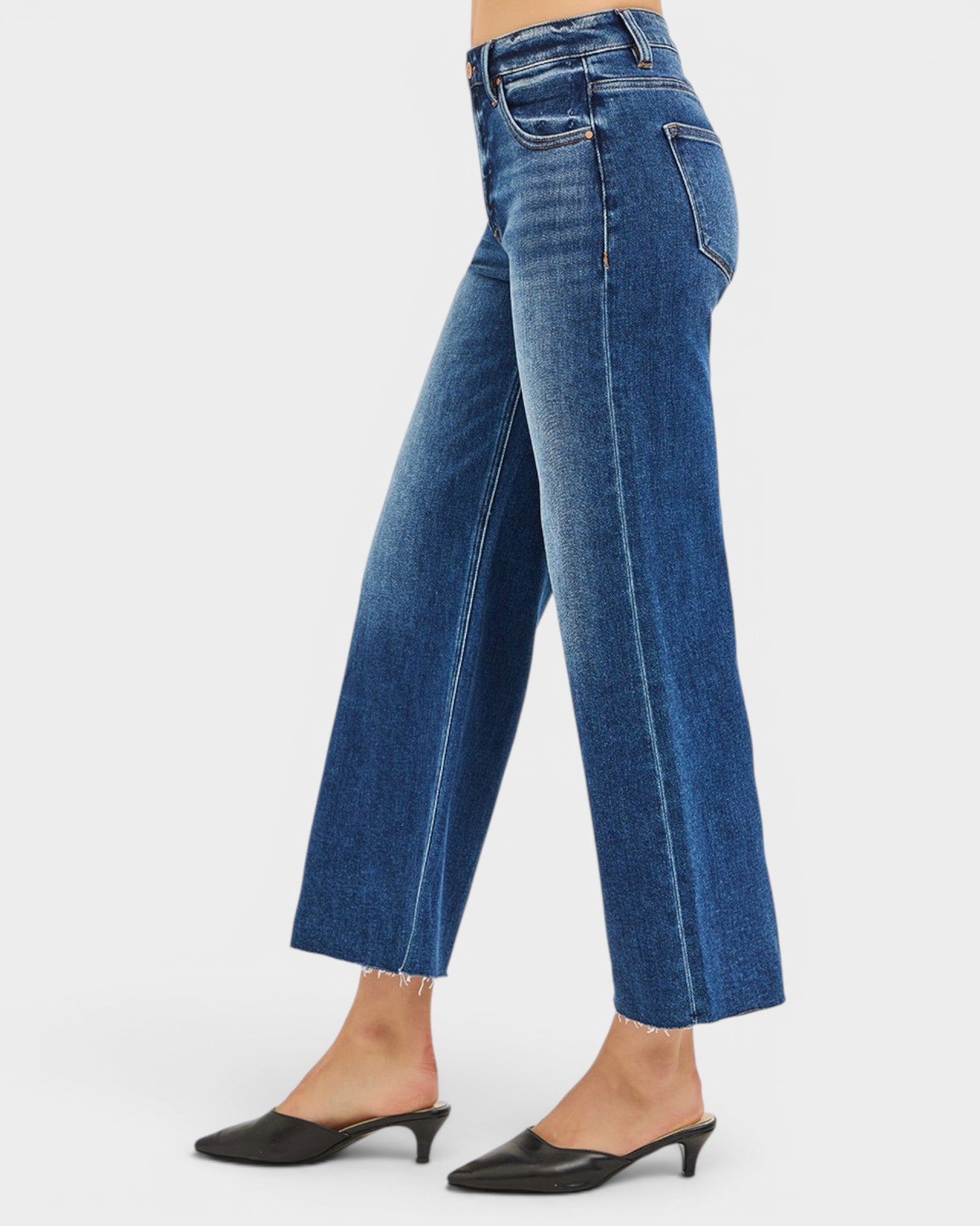 Blue jeans worn by a person on a white background