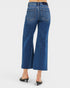 Blue jeans worn by a person on a white background