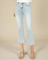 Light blue jeans worn by a person on a beige background