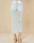 Light blue jeans worn by a person on a beige background