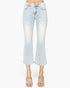 Light-wash cropped flare jeans shown on a model from the waist down, paired with beige strappy heeled sandals against a plain white background.