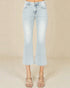 Light blue jeans worn by a person on a beige background