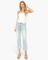A woman modeling a white strapless tube top and light-wash cropped flare jeans with beige heeled sandals, photographed against a plain light gray studio background.