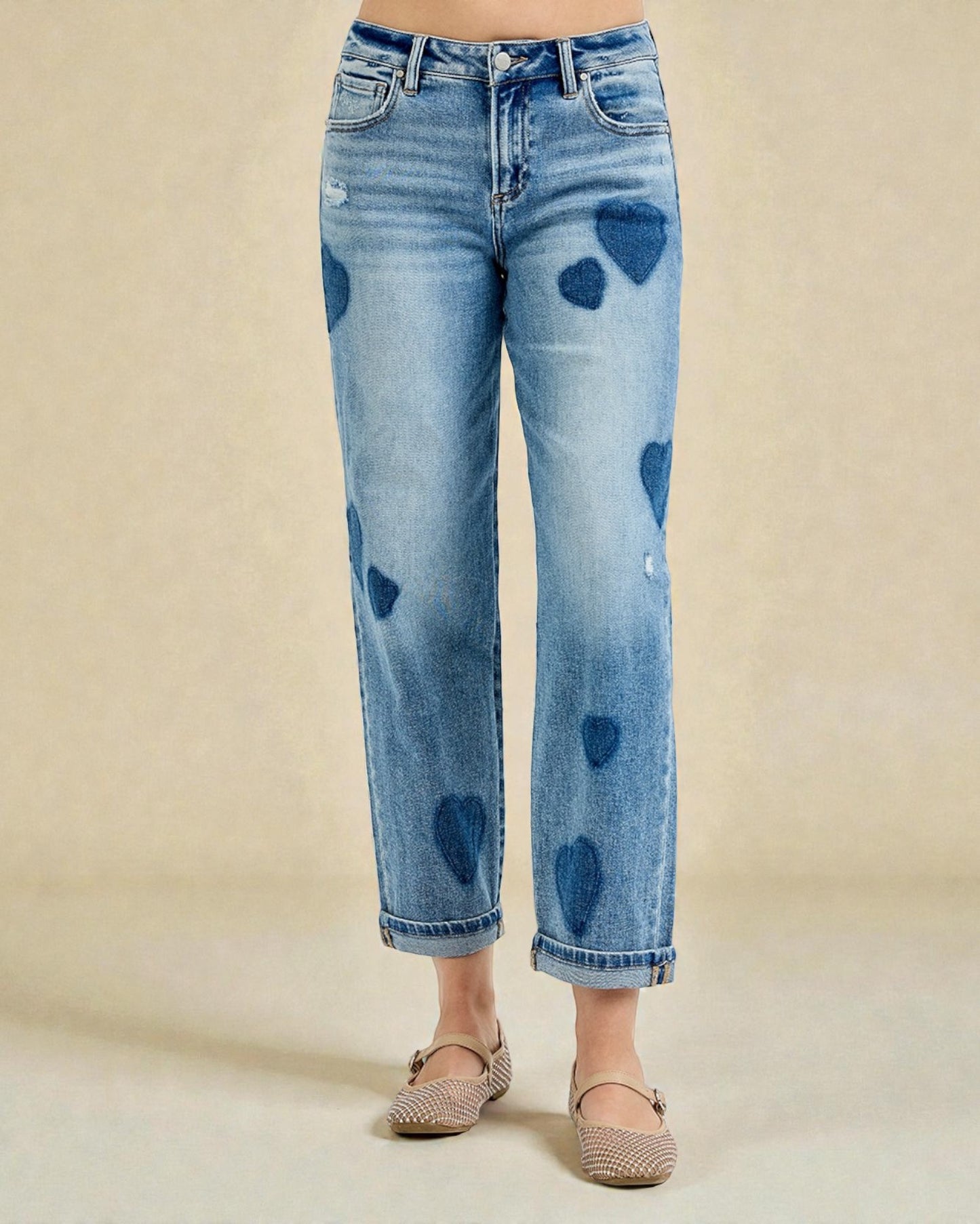 Blue jeans with heart shapes on a beige background