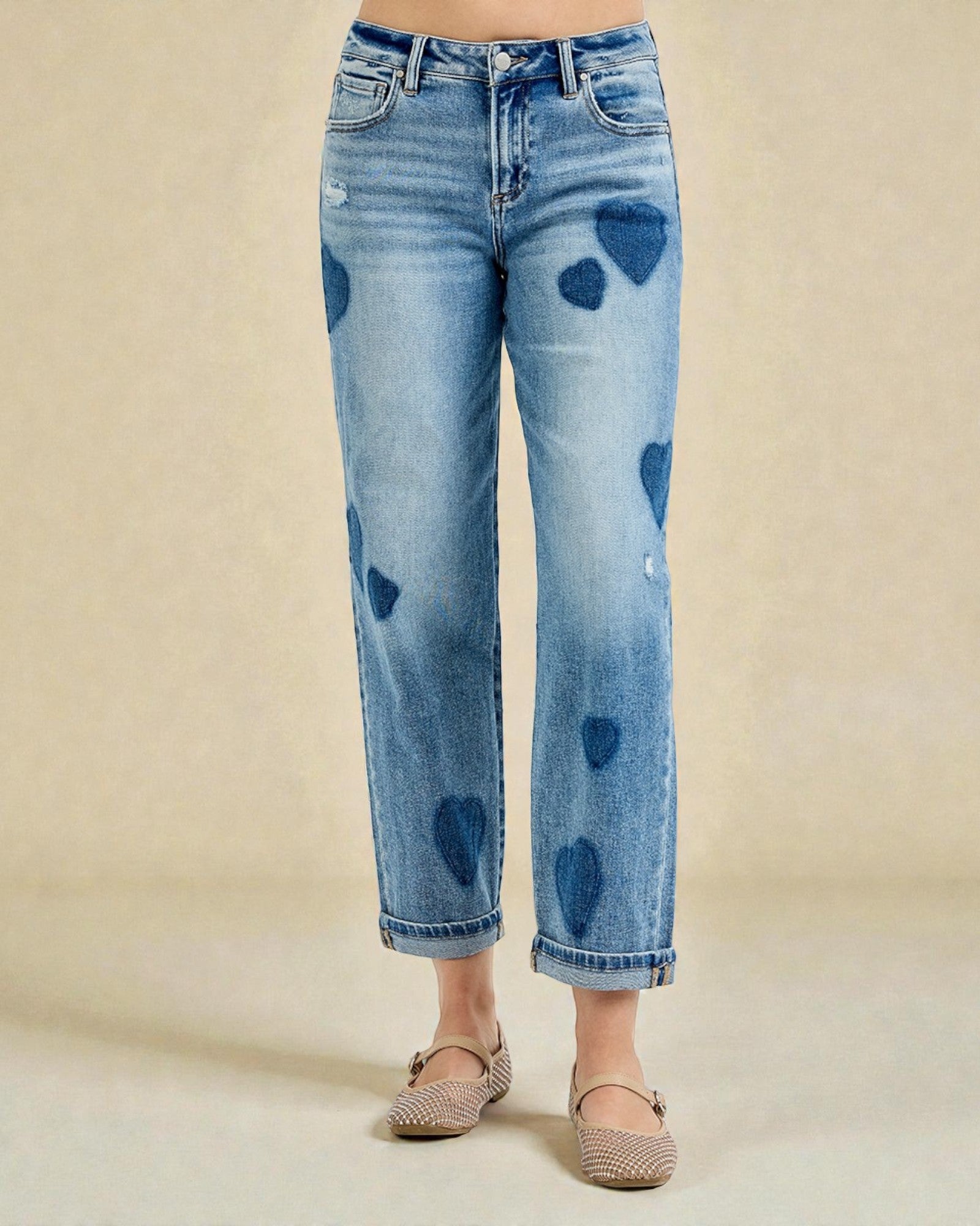 Blue jeans with heart shapes on a beige background