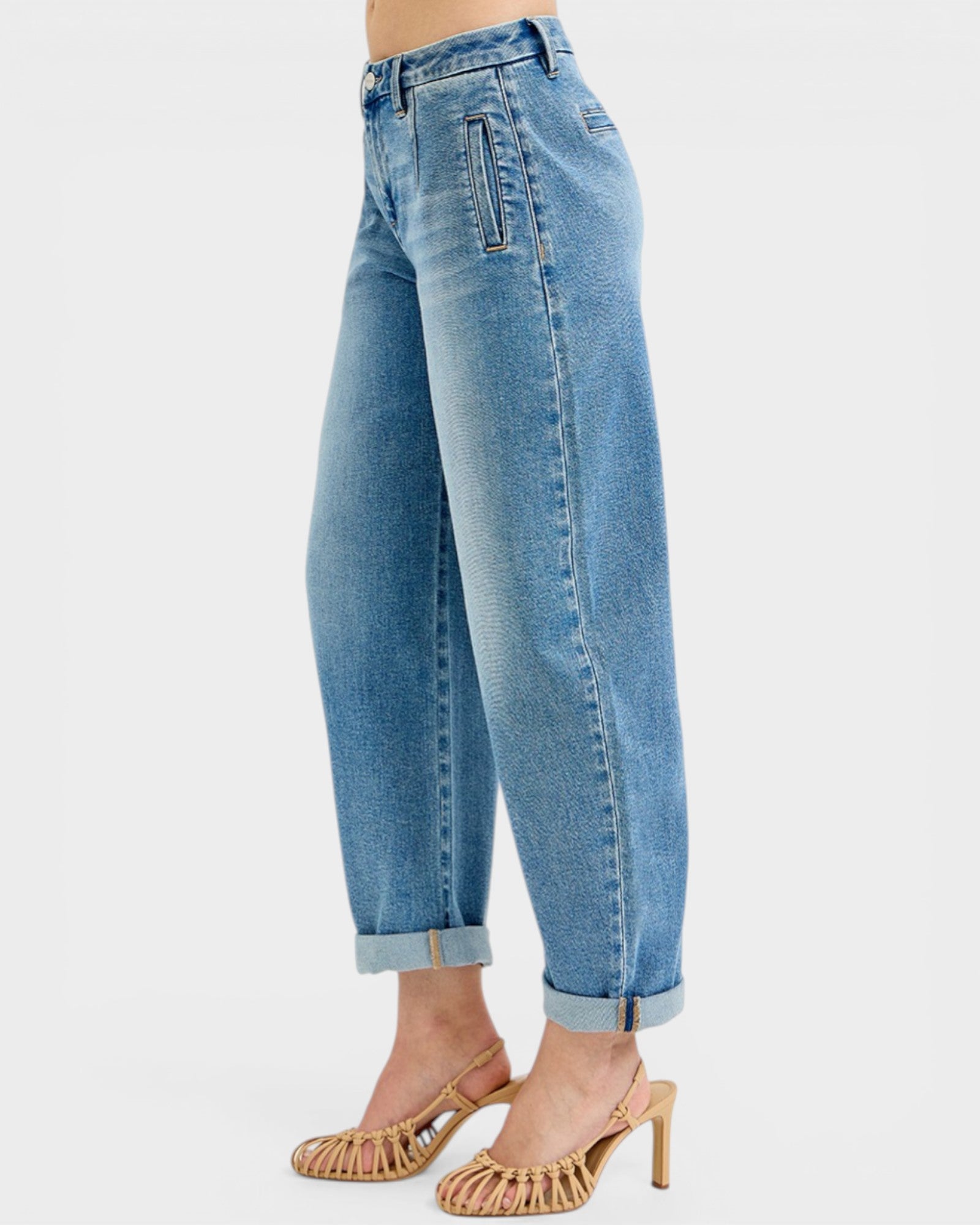 Blue jeans worn by a person on a white background