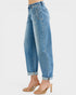 Blue jeans worn by a person on a white background