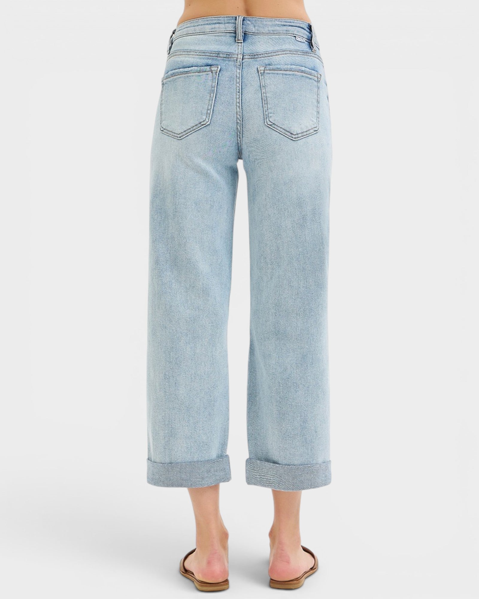 Light blue jeans worn by a person on a white background