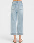 Light blue jeans worn by a person on a white background