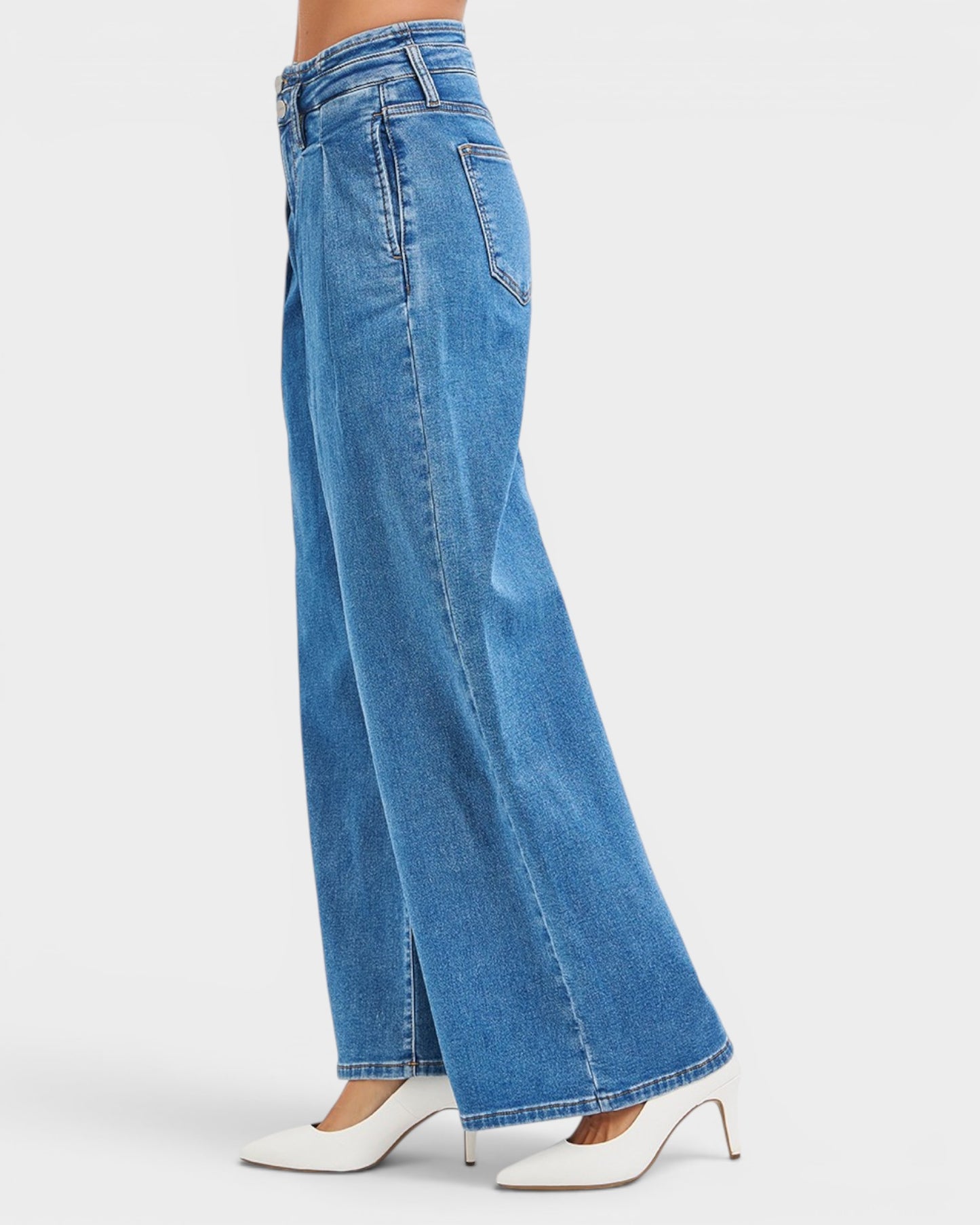 Blue jeans worn by a person on a white background