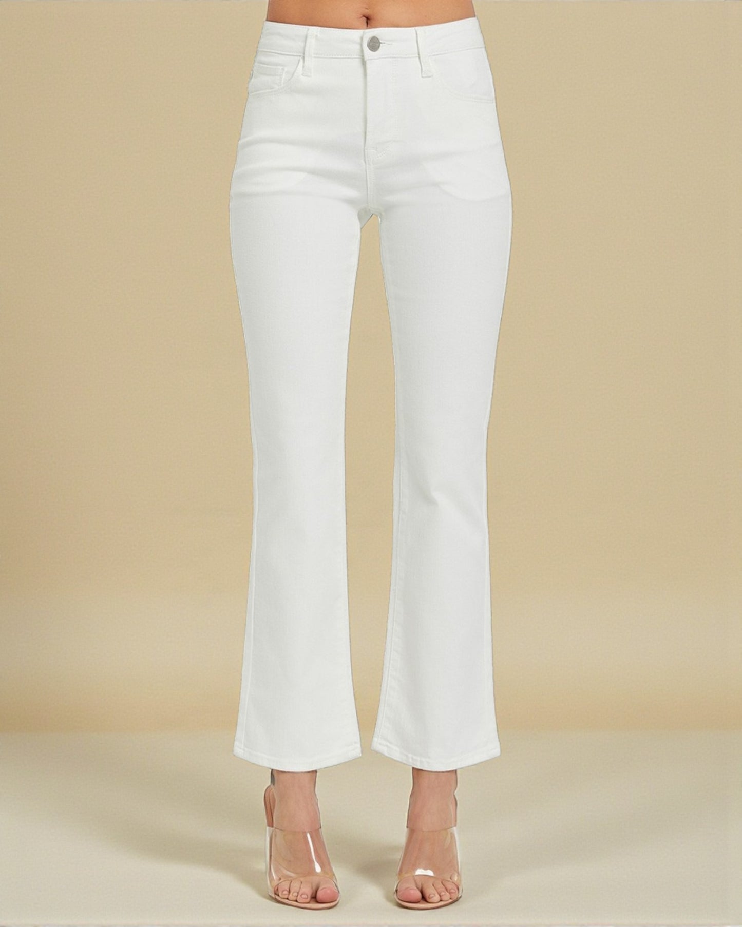 White jeans worn by a person on a beige background