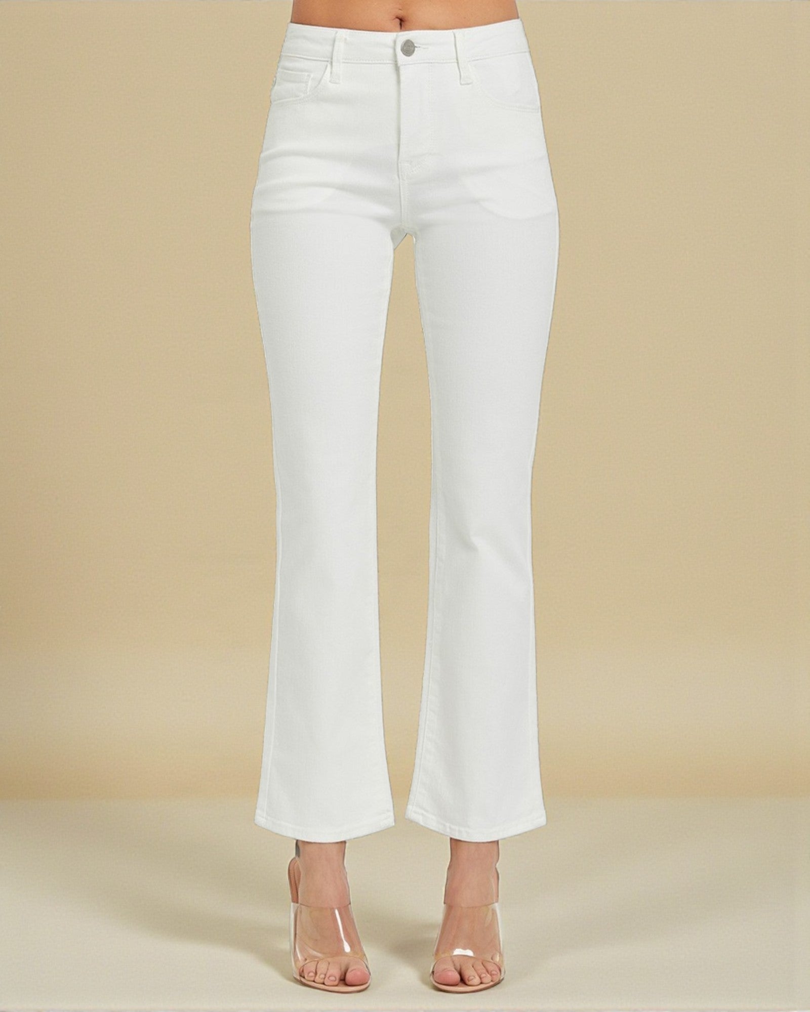 White jeans worn by a person on a beige background