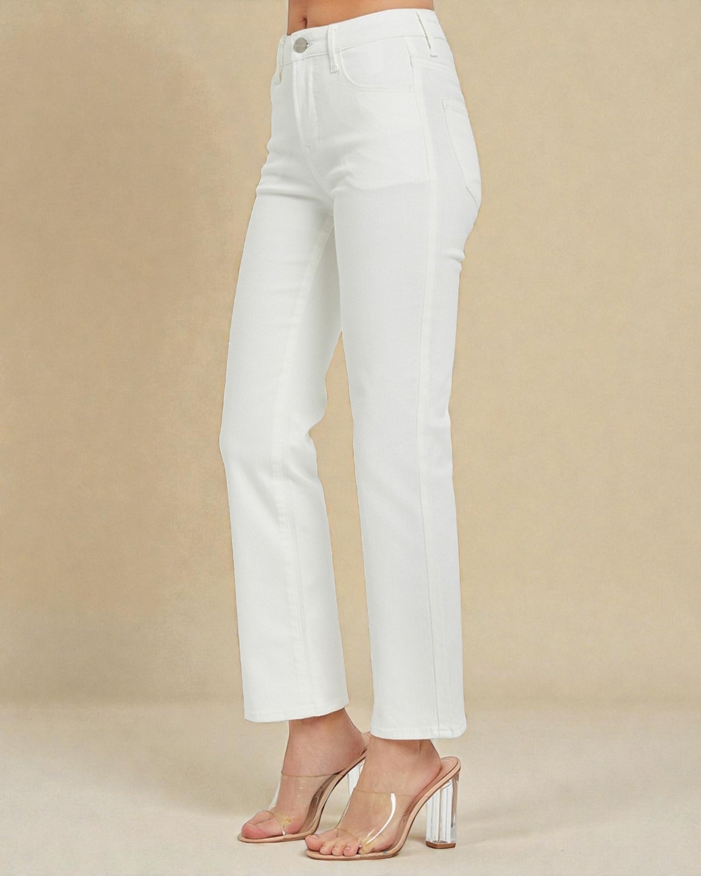 White jeans worn by a person on a beige background