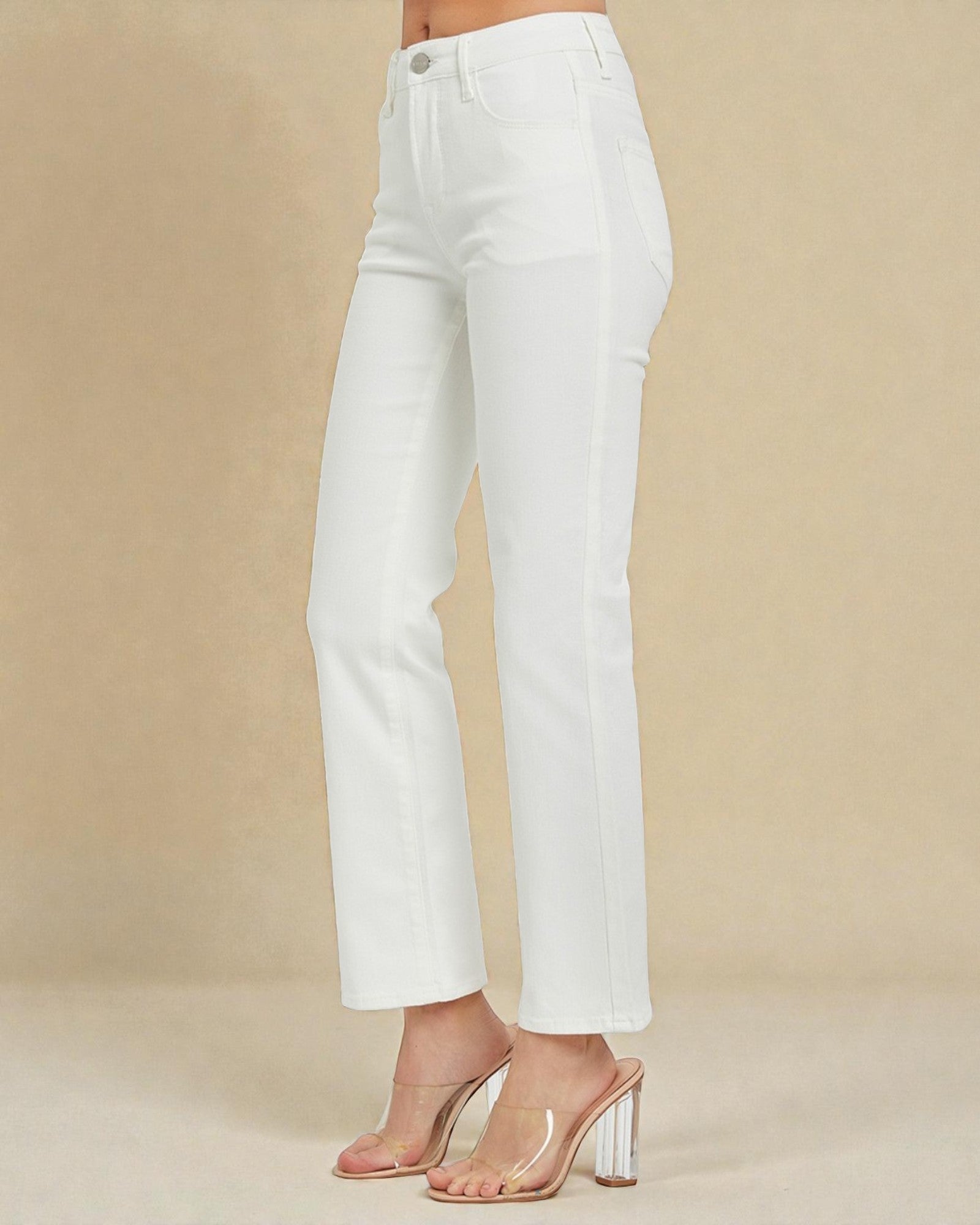 White jeans worn by a person on a beige background