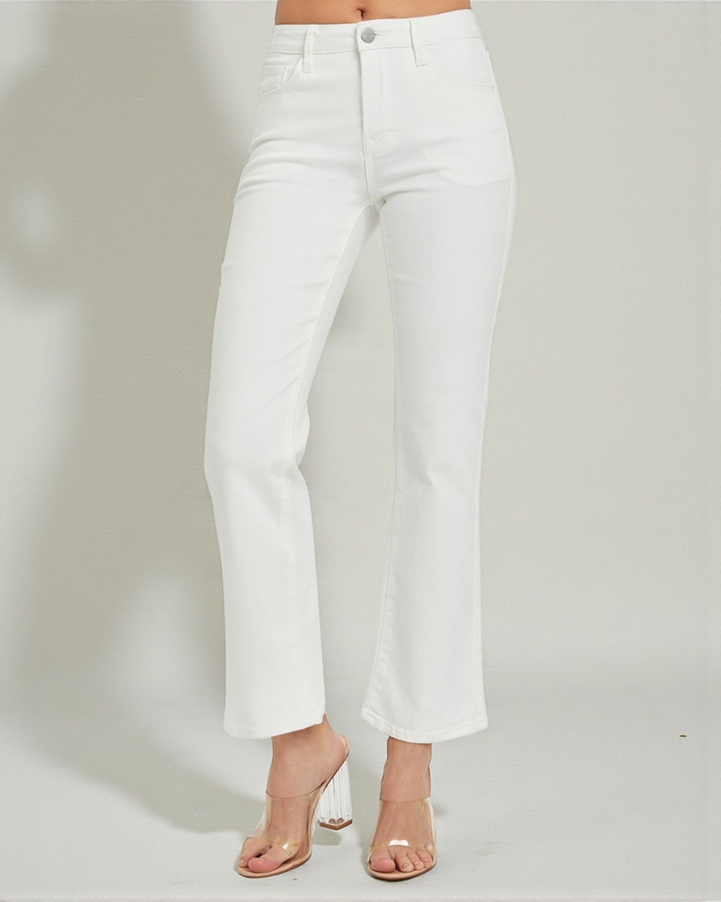 White pants worn by a person on a plain background