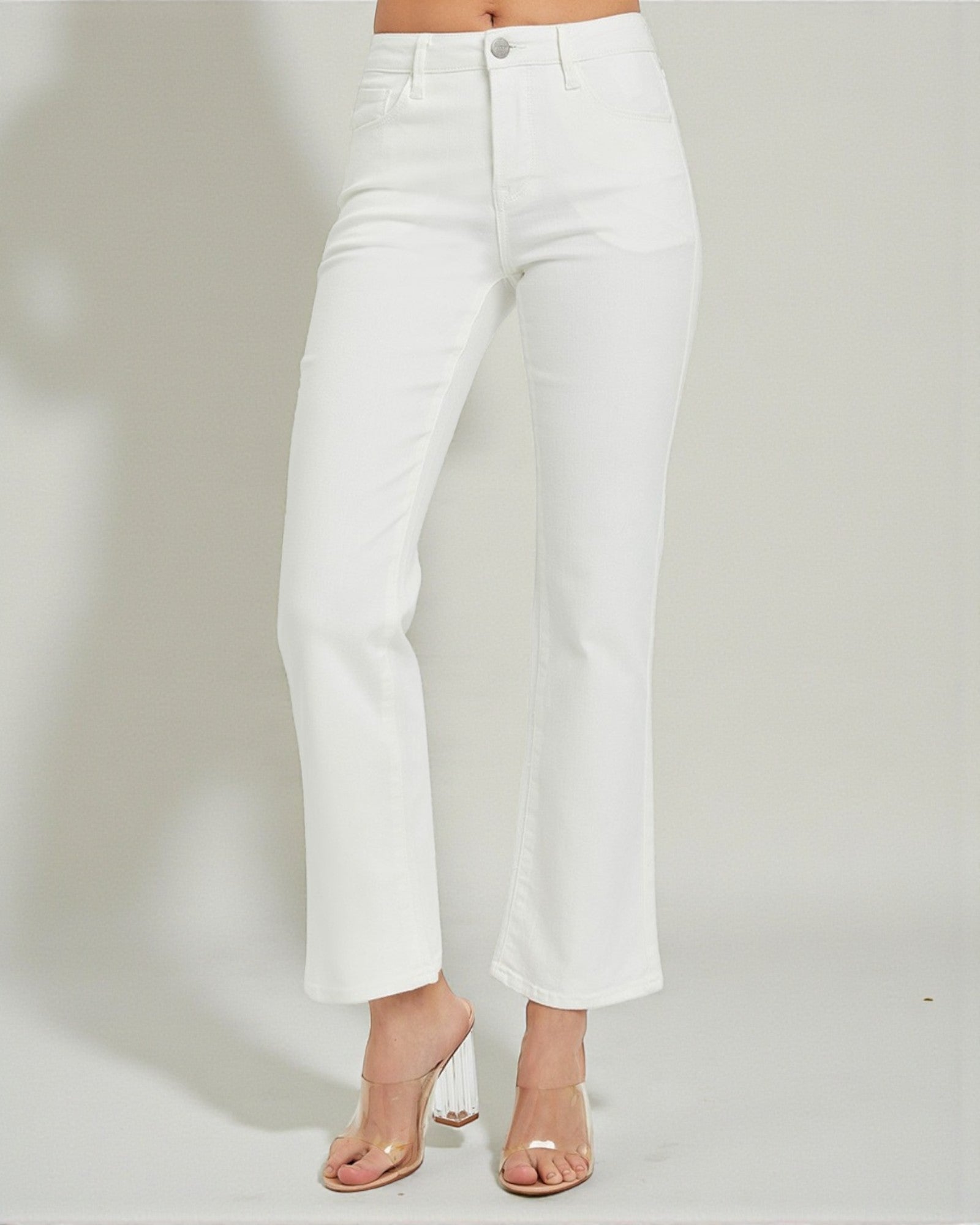 White pants worn by a person on a plain background
