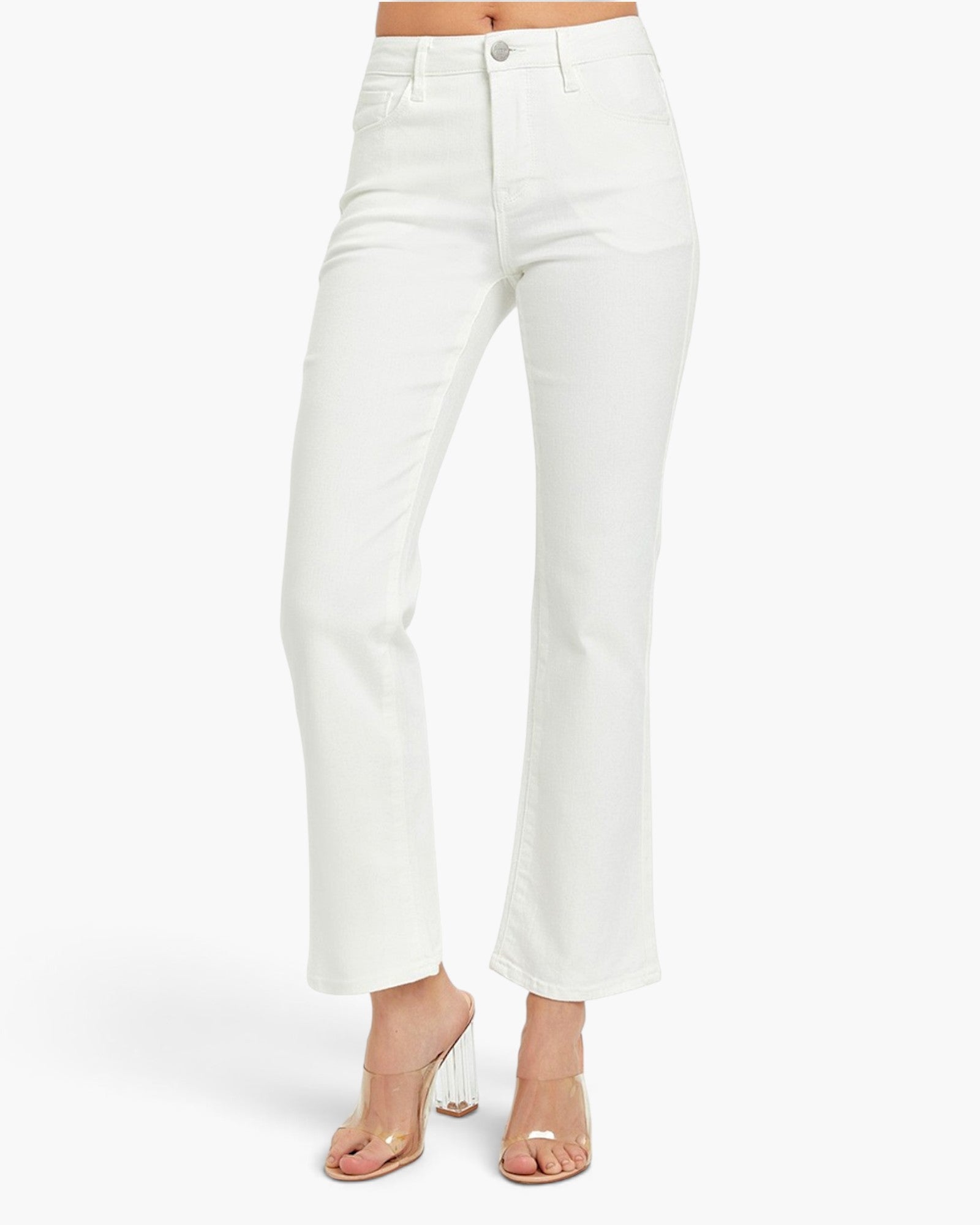 White cropped flare jeans shown on a model from the waist down, paired with clear high-heel sandals against a clean white background.