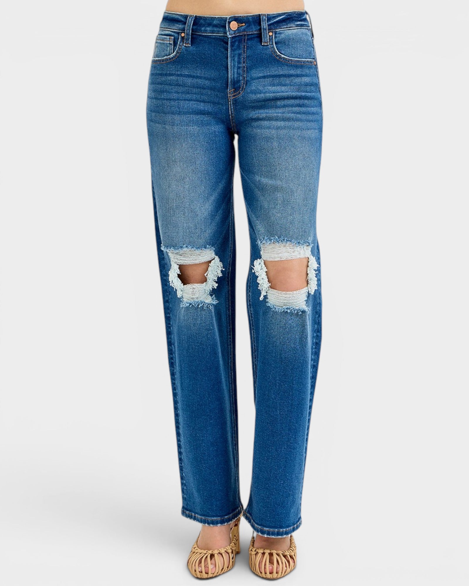 Blue jeans with distressing on a white background